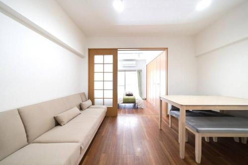 a living room with a couch and a table at Shibuya E Address 303 in Tokyo