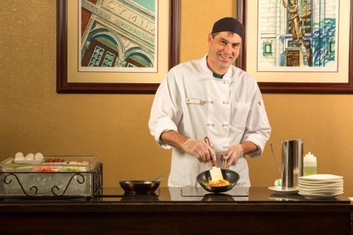 a chef preparing food in a bowl on a counter at DoubleTree by Hilton Biltmore/Asheville in Asheville