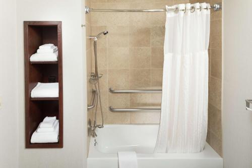 a bathroom with a shower with a white shower curtain at DoubleTree by Hilton Biltmore/Asheville in Asheville