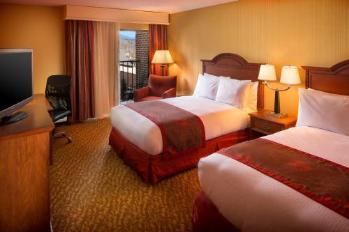 a hotel room with two beds and a television at DoubleTree by Hilton Biltmore/Asheville in Asheville