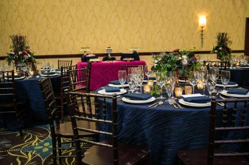 a table with a blue table cloth and chairs with glasses at DoubleTree by Hilton Biltmore/Asheville in Asheville