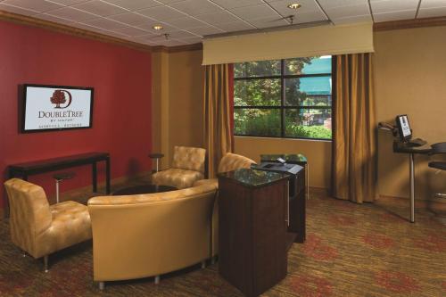 a waiting room with chairs and a desk and a window at DoubleTree by Hilton Biltmore/Asheville in Asheville