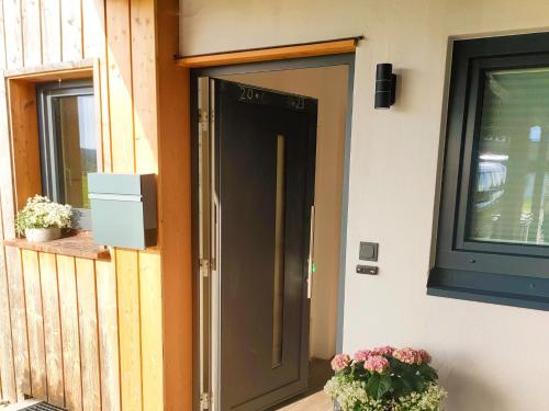 a door on the side of a house with flowers at Ferienwohnung Werner in Inzell