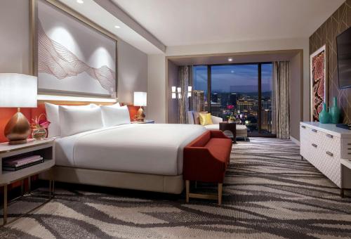a bedroom with a large bed and a large window at Conrad Las Vegas At Resorts World in Las Vegas