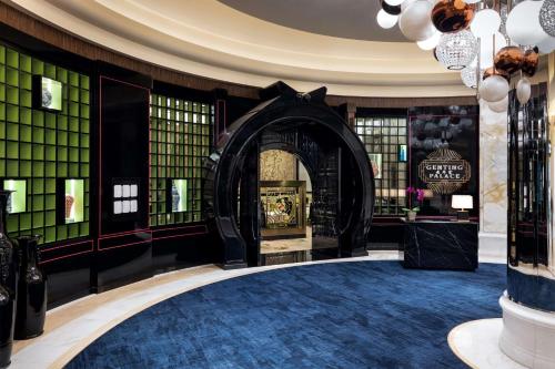 a lobby with a fireplace in the middle of a building at Conrad Las Vegas At Resorts World in Las Vegas
