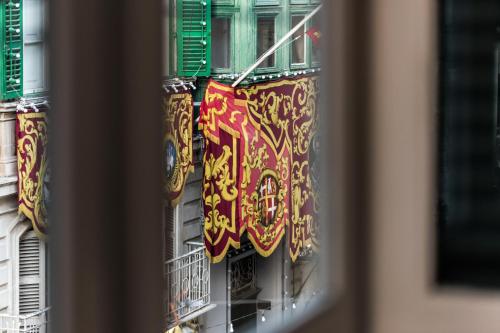 a window with colorful flags on a building at Domus Zamittello in Valletta