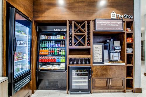 a coffee shop with a counter and a refrigerator at Hilton Garden Inn Dallas-Central Expy/North Park Area, Tx in Dallas
