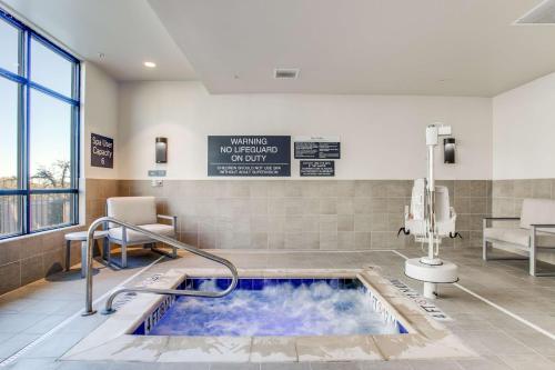 a hot tub in a hospital room with a sign at Hilton Garden Inn Dallas-Central Expy/North Park Area, Tx in Dallas