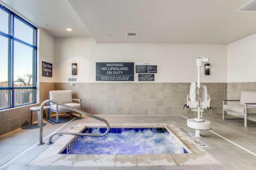 a hot tub in a hospital room with a sign at Hilton Garden Inn Dallas-Central Expy/North Park Area, Tx in Dallas