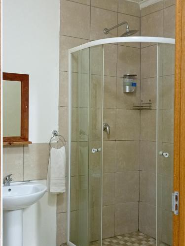 a bathroom with a shower and a sink at 21 On Coetzee Guest House in Bloemfontein