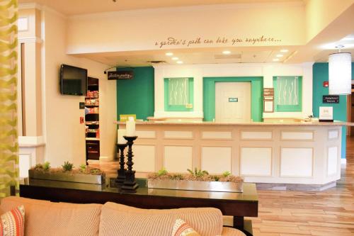 a lobby with a waiting room with a couch and a counter at Hilton Garden Inn Redding in Redding