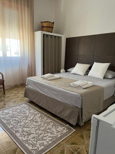a bedroom with a large bed in a room at Villa Zagara in Marsala