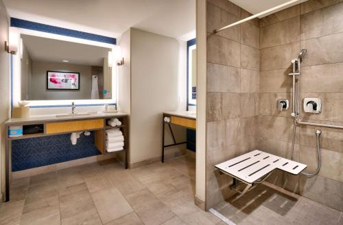 a bathroom with a shower and a sink at Hilton Garden Inn Bozeman in Bozeman
