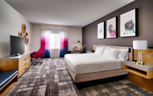 a hotel room with a bed and a television at Hilton Garden Inn Bozeman in Bozeman