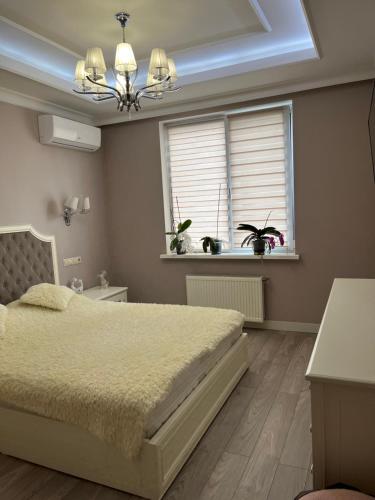 sypialnia z dużym łóżkiem i oknem w obiekcie Apartament in the center of Chisinau w Kiszyniowie