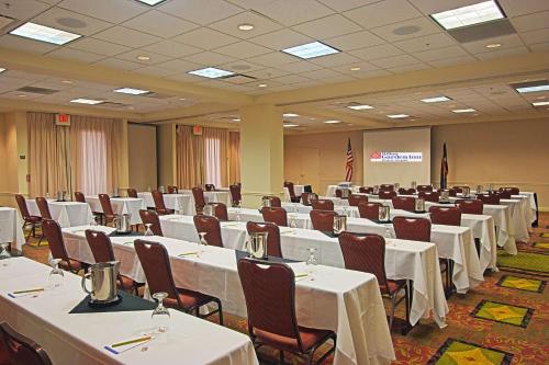 a conference room with tables and chairs in it at Hilton Garden Inn Denver Airport in Aurora