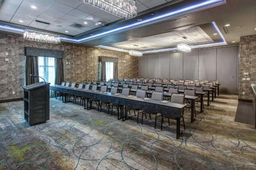 a conference room with tables and chairs and a podium at Hilton Garden Inn Topeka in Topeka
