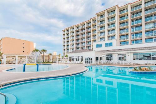 a swimming pool in front of a hotel at Hilton Pensacola Beach in Pensacola Beach