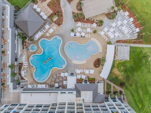 an aerial view of a pool at a resort at Hilton Pensacola Beach in Pensacola Beach
