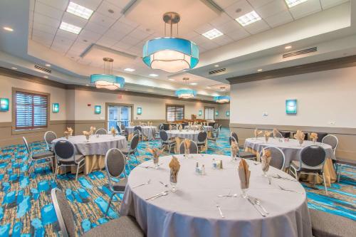 a banquet hall with tables and chairs in a room at Hilton Pensacola Beach in Pensacola Beach