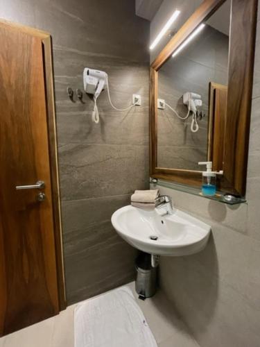 a bathroom with a sink and a mirror at B&B Noce Zagreb in Zagreb