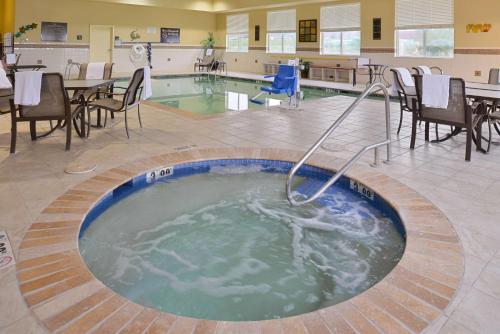 a hot tub in the middle of a room with tables and chairs at Hampton Inn Alpine in Alpine