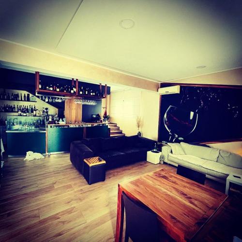a living room with a couch and a bar at B&B Noce Zagreb in Zagreb