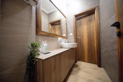 a bathroom with a sink and a mirror at B&B Noce Zagreb in Zagreb