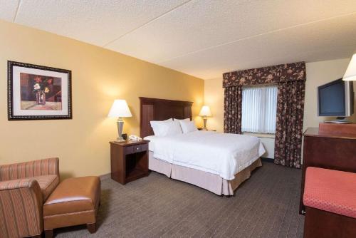 a hotel room with a bed and a television at Hampton Inn Schenectady Downtown in Schenectady