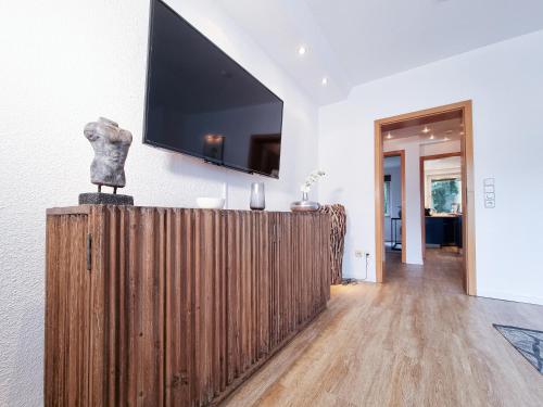 a living room with a television on a wall at Alpha Apartments in Essen