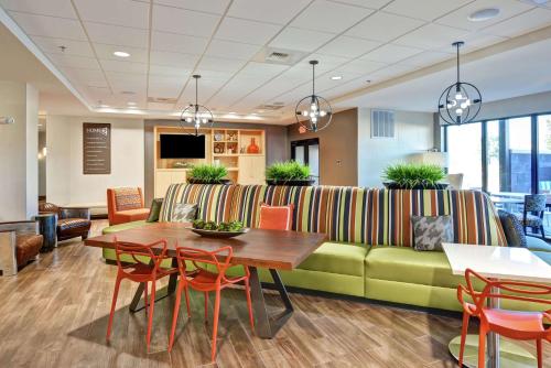 a living room with a couch and a table and chairs at Home2 Suites By Hilton Conway in Conway