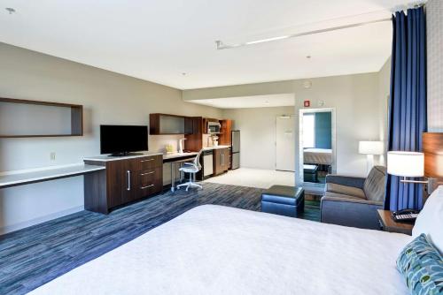 a hotel room with a bed and a living room at Home2 Suites By Hilton Conway in Conway