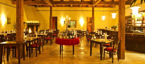 a restaurant with tables and chairs and a bar at Schloss Reinach in Freiburg im Breisgau