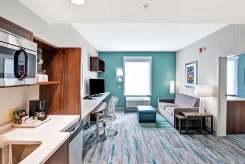 a hotel room with a kitchen and a living room at Home2 Suites By Hilton Conway in Conway