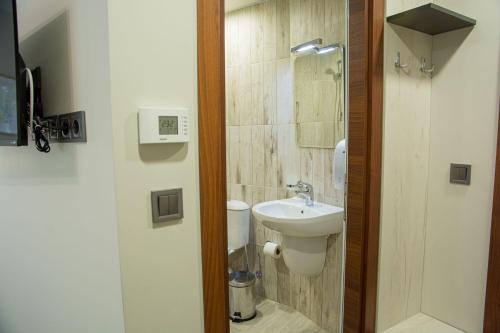 a small bathroom with a sink and a toilet at Arima city in Shumen