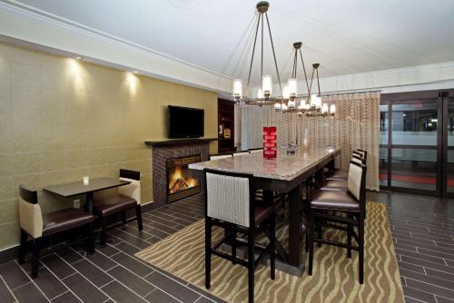 a dining room with a table and chairs and a fireplace at Hampton Inn Philadelphia-Great Valley in Frazer