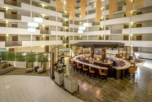 a lobby of a hotel with a bar and chairs at DoubleTree by Hilton Montgomery Downtown in Montgomery