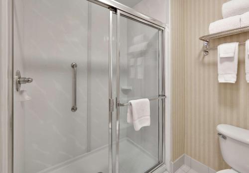 a bathroom with a shower with a glass door at Homewood Suites by Hilton San Diego-Del Mar in San Diego