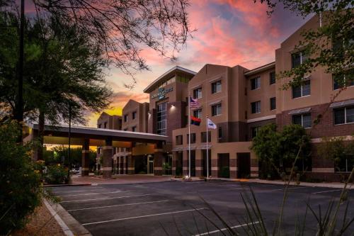 an empty parking lot in front of a hotel at Homewood Suites by Hilton Phoenix Airport South in Phoenix