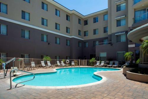 a swimming pool in front of a building at Homewood Suites by Hilton Phoenix Airport South in Phoenix