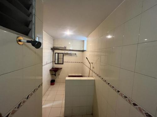 a bathroom with a hallway with a sink and a staircase at Hotel City Tower, Chennai Central in Chennai