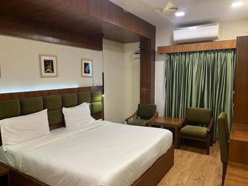 a hotel room with a bed and a desk and chair at Hotel City Tower, Chennai Central in Chennai