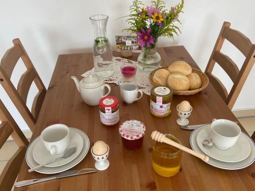 uma mesa com pratos, copos e pão em Gemütliche Wohnung in Genthin OT Tucheim em Tucheim
