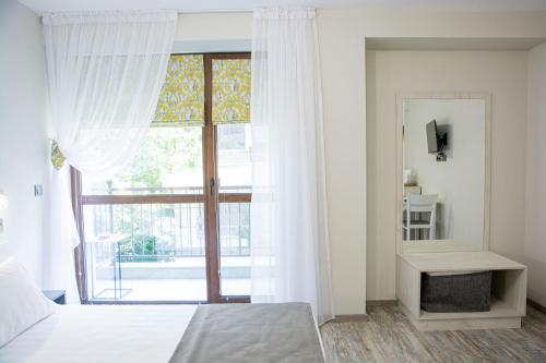 a bedroom with a bed and a large window at Arima city in Shumen