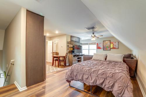 a bedroom with a bed and a living room at Cozy Covington Studio Rental Near Historic Square! in Covington