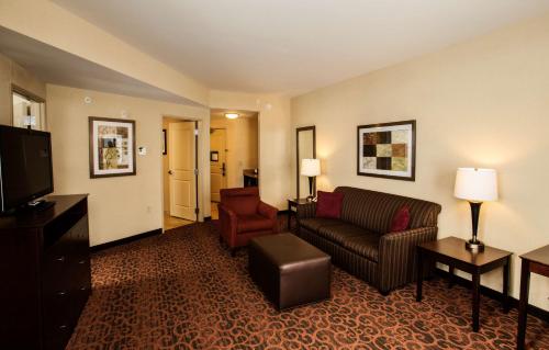 a living room with a couch and a television at Hampton Inn Marquette-Waterfront in Marquette
