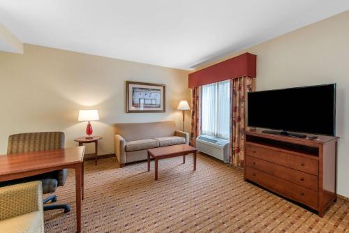 a living room with a flat screen tv and a couch at Hampton Inn & Suites Arcata in Arcata