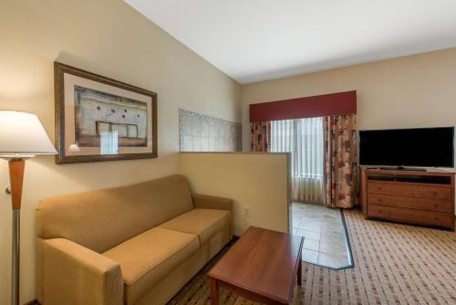 a living room with a couch and a flat screen tv at Hampton Inn & Suites Arcata in Arcata