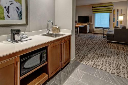 a kitchen with a sink and a living room at Hampton Inn & Suites Nashville/Goodlettsville Tennessee in Goodlettsville