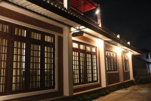 a building with lights on the side of it at night at Windy Hanthana in Kandy